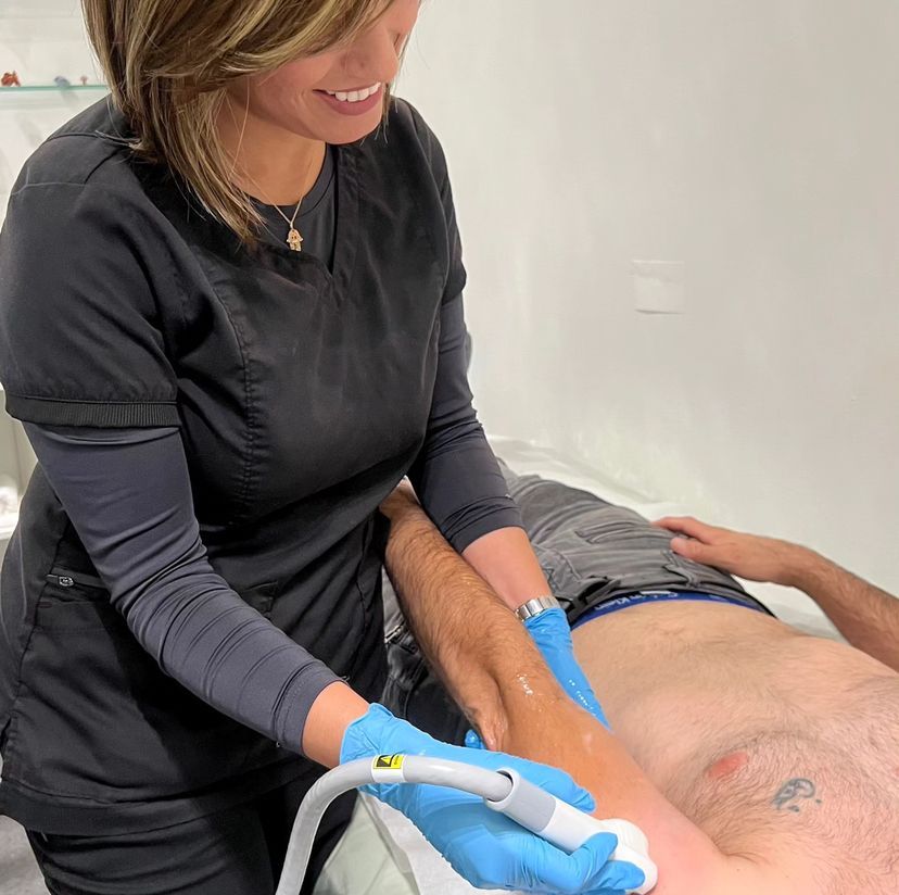 Woman receiving non-invasive Venus Legacy body contouring treatment, showcasing advanced skincare technology for body toning and cellulite reduction.